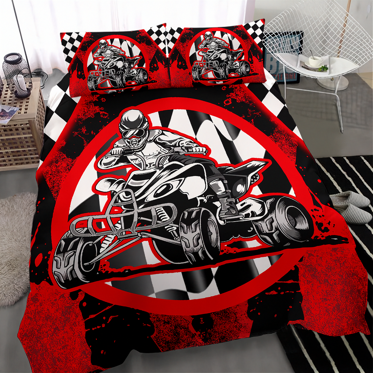 A bed dressed in a motocross-themed bedding set featuring a large red, black, and white graphic of a rider on a quad bike, with two matching pillowcases, shown in a modern bedroom setting.
