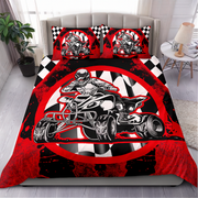 A bedding set displayed on a bed in a styled bedroom, featuring a red, black, and white quad bike racing graphic on the comforter and matching pillowcases with a checkered pattern.