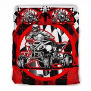 A racing-themed bedding set featuring a duvet cover and two pillowcases with a bold graphic print of a motocross racer on a quad bike, set against a red, black, and white checkered background.
