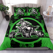 A bedding set featuring a duvet cover and two pillowcases with a high-contrast graphic print of a person riding a quad bike on a black and bright green background, displayed on a bed in a modern bedroom setting.