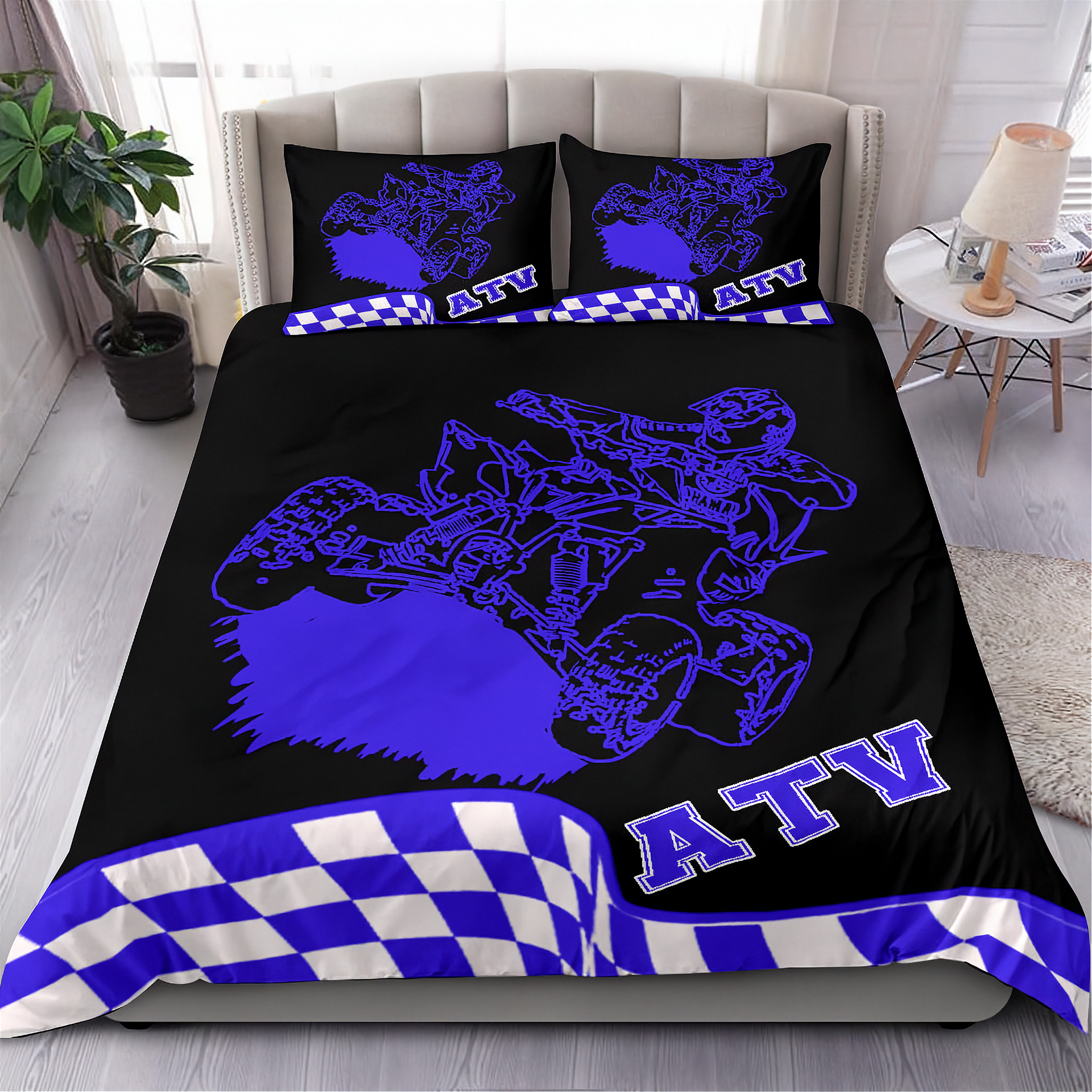 Bedding set with ATV design in blue on a black background, featuring checkered patterns, in a bedroom setting.