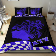 Black and blue ATV-themed bedding set on a bed in a room.