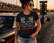 A sassy and fun apparel design featuring the phrase "These Titties Are Taken By A Super Sexy Drag Racer" printed on premium women's t-shirts, crop tops, and hoodies.