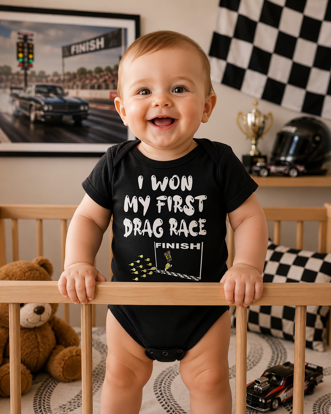 Baby onesie featuring the "I Won My First Drag Race" graphic, designed with a reinforced three-snap closure and 100% combed ringspun cotton rib.