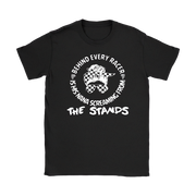 black shirt with a white graphic print that reads 'BEHIND EVERY RACER IS HIS NANA SCREAMING FROM THE STANDS' with a checkerboard flag design.