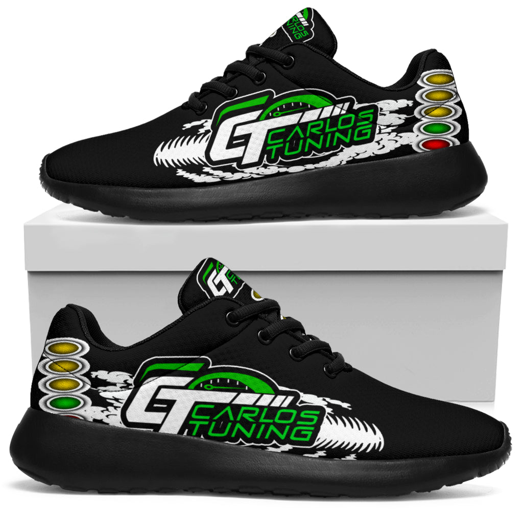 Black custom drag racing sneakers displayed on a white box, with green-and-white Carlos Tuning sample logos, tire tracks, and starting lights.