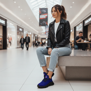 Woman sitting on a bench in a shopping mall wearing a black leather jacket and blue checkered shoes.