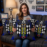 Woman sitting on a sofa at themed drag racing living room holding a drag racing pillow with big DRAG RACING Christmas tree