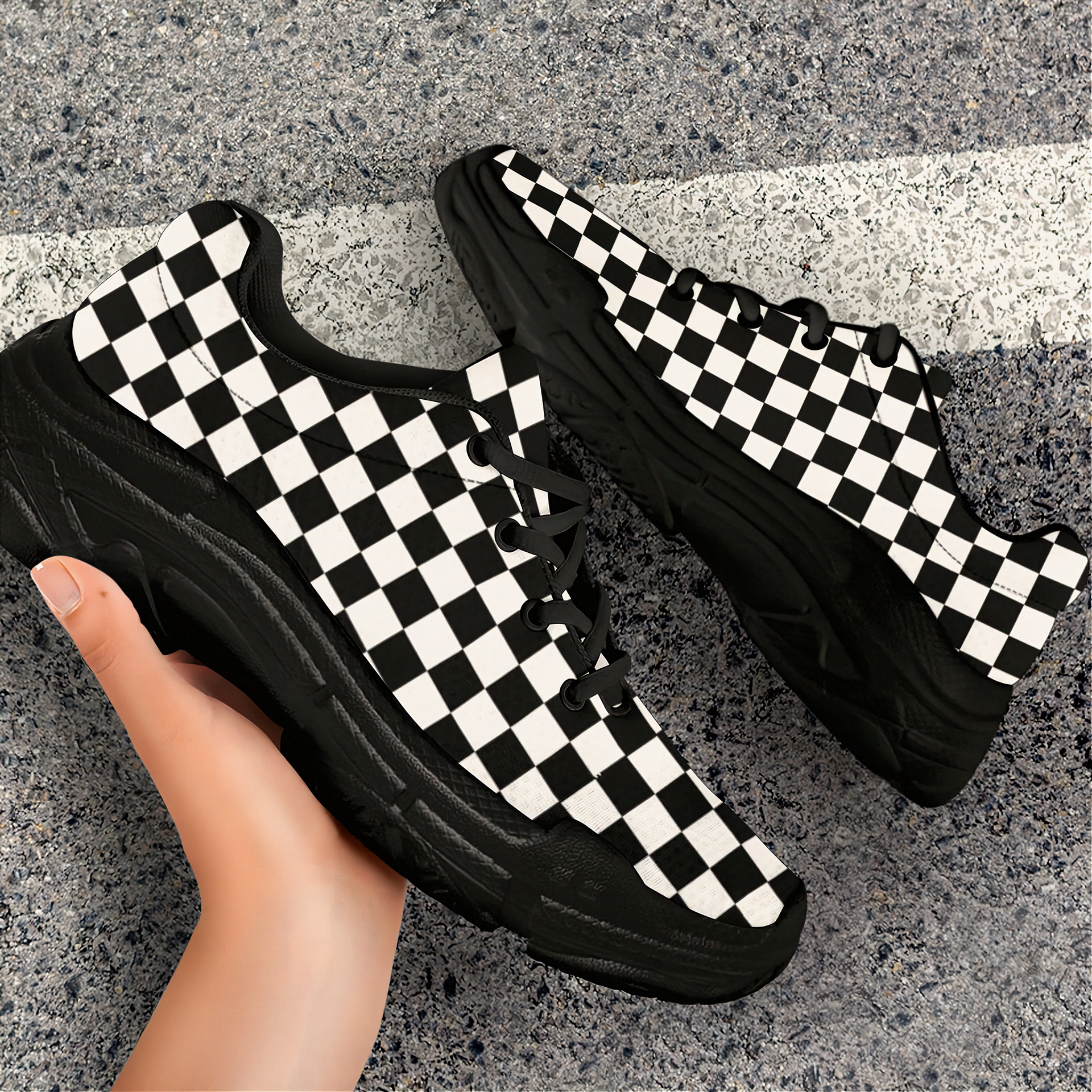 Black and white checkered sneakers on a gray concrete surface