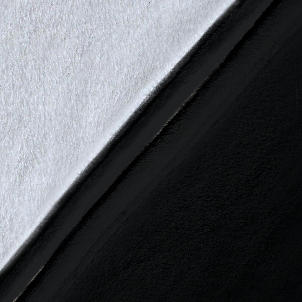 Close-up of the blanket’s white microfleece backing, black printed surface, and stitched black edge.