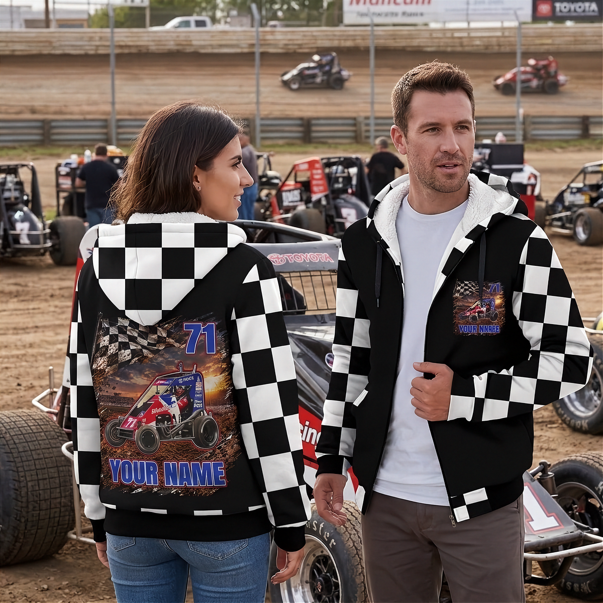 Couple in the midget racing pits showing the jacket’s personalized back artwork and matching chest graphic.
