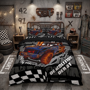 A racing-themed bedding set featuring a blue and orange demolition derby truck graphic on a black and gray background with a checkered flag border, styled in a rustic industrial bedroom setting.