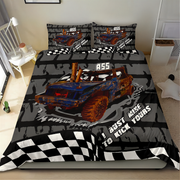 A racing-themed bedding set featuring a duvet cover and two matching pillowcases with a graphic of a blue and orange race car, checkered black and white borders, and the text 'I GUEST MINE TO KICK YOURS' and '855'. The set is displayed on a bed in a bedroom setting.