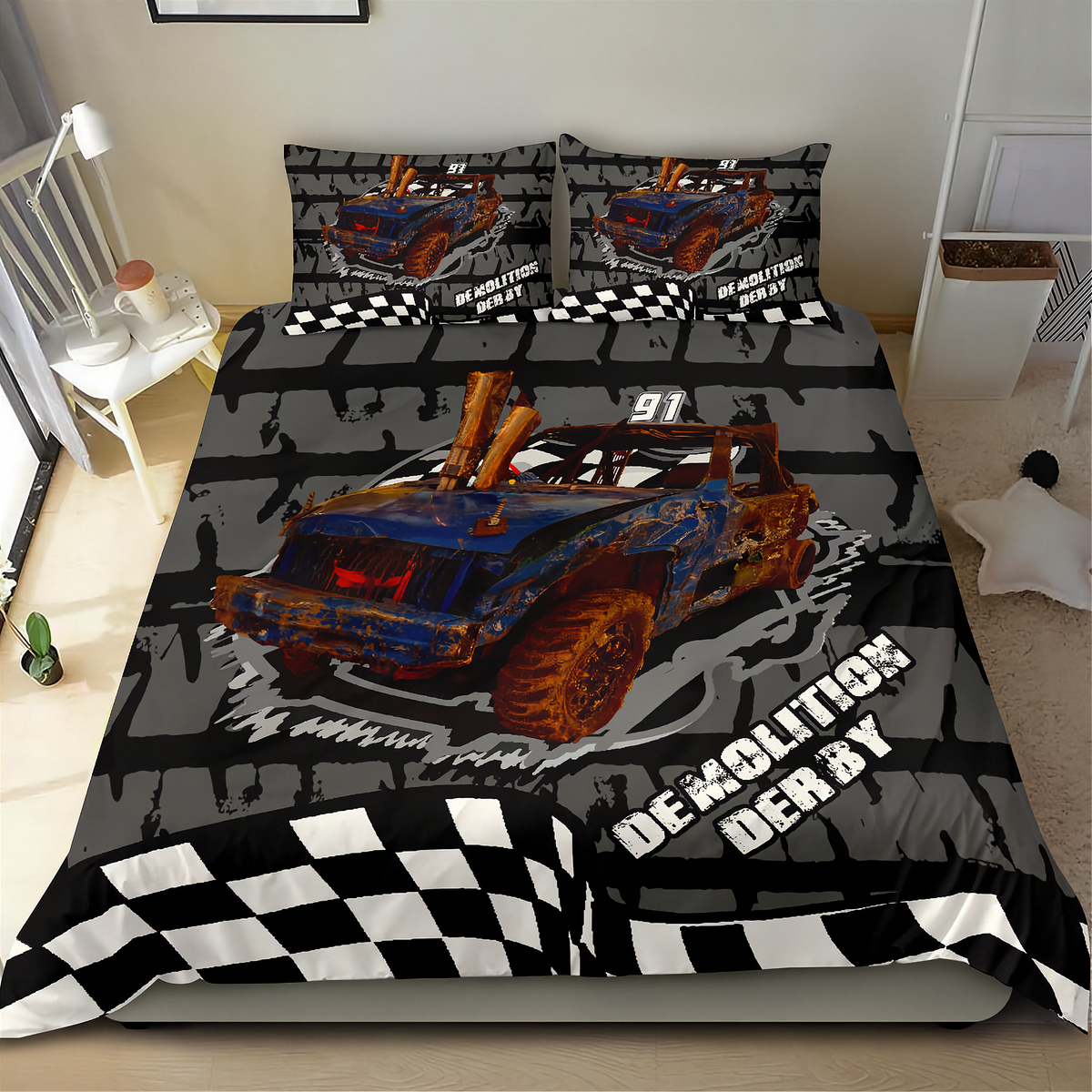 A racing-themed bedding set featuring a duvet cover and two pillowcases with a graphic of a blue and orange race car, checkered flags, and the words 'Demolition DERBY' on a gray background, shown on a bed in a bedroom.