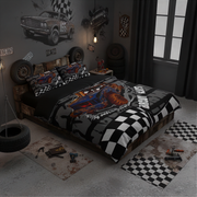 A racing-themed bedding set displayed on a bed in a dark, styled bedroom. The set includes a duvet cover and two pillowcases featuring a graphic of a blue race car on a gray camouflage background with a black-and-white checkered stripe.
