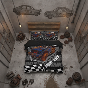 A top-down view of a bed dressed in a racing-themed duvet cover and pillowcases, placed in a gritty industrial room with concrete walls, hanging lights, and racing car graphics on the wall.