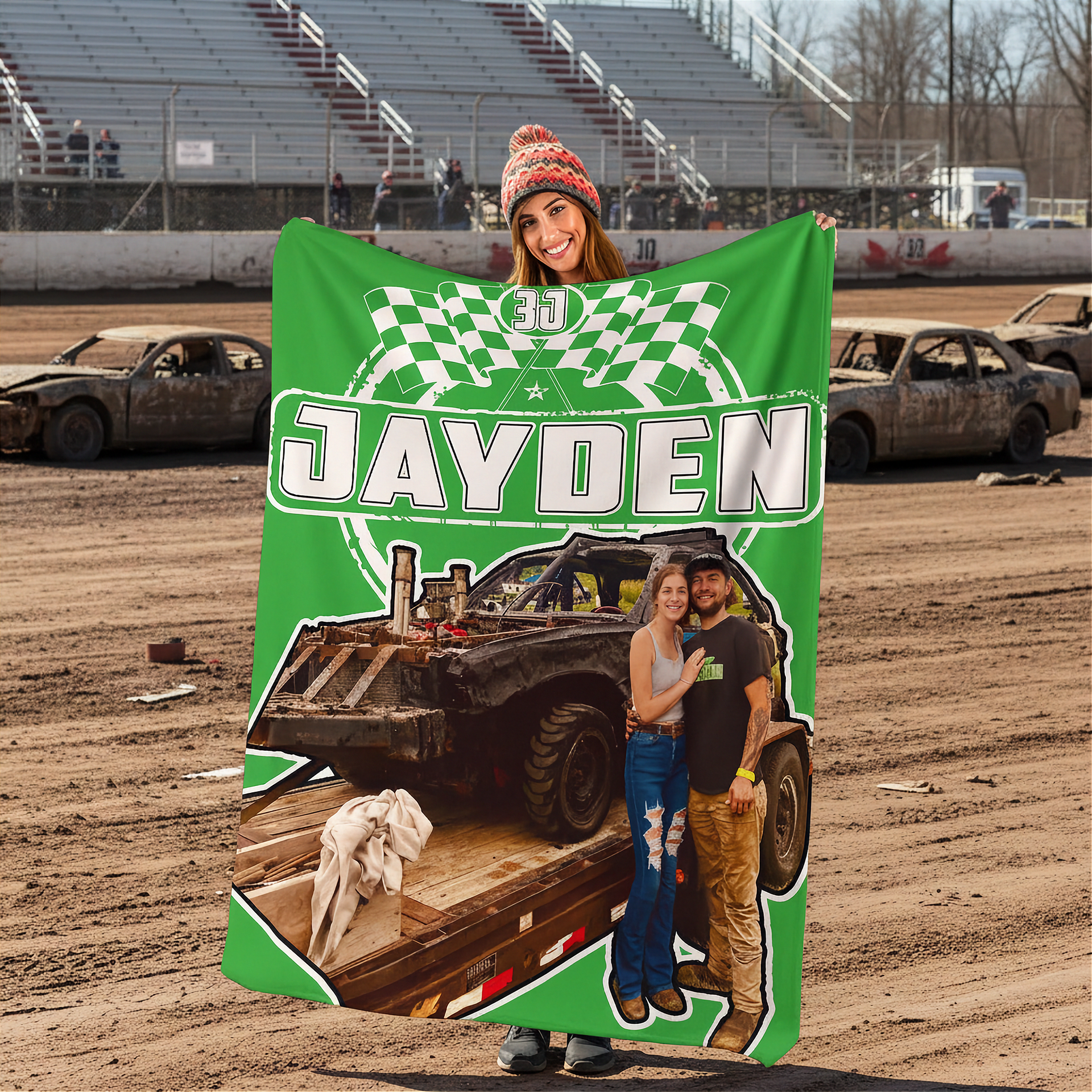 woman in a dirt track holding a green custom demolition derby blanket