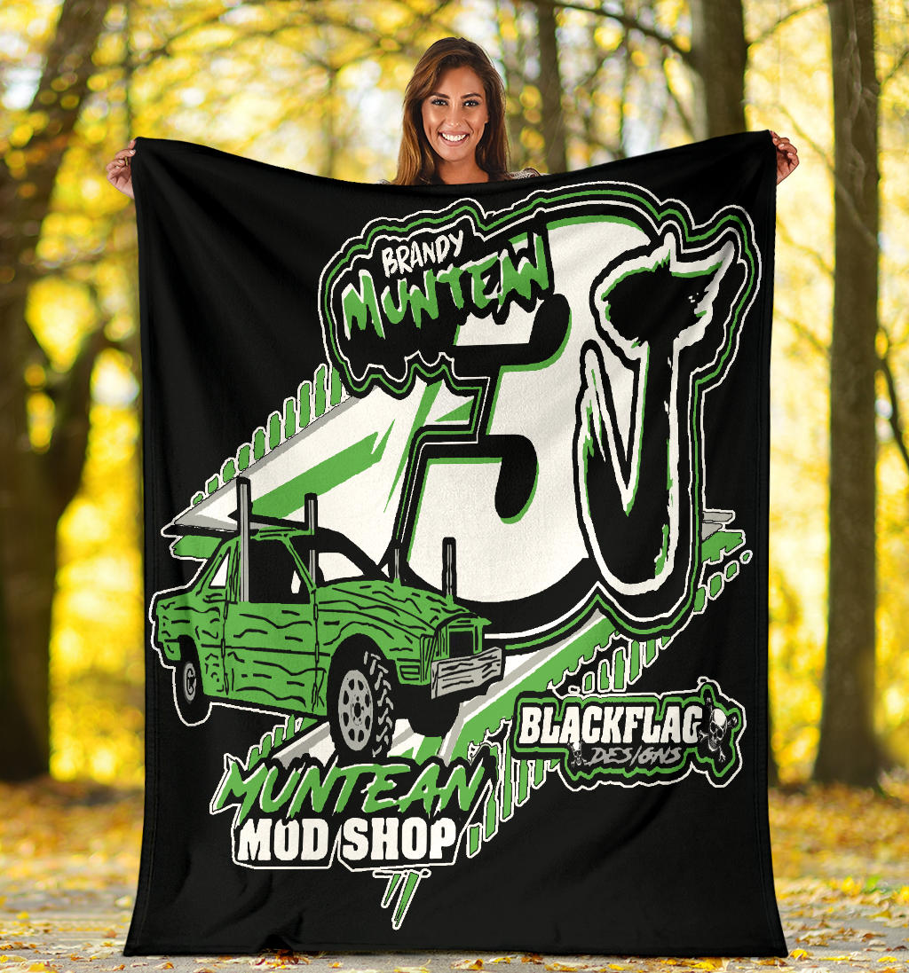 woman holding a green and white custom demolition derby blanket