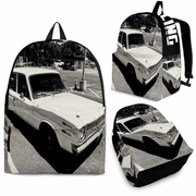 A backpack shown from multiple angles on a white background, printed with a black-and-white photograph of a vintage car. The backpack has black shoulder straps and side trim, and the print is a high-contrast monochrome scene.