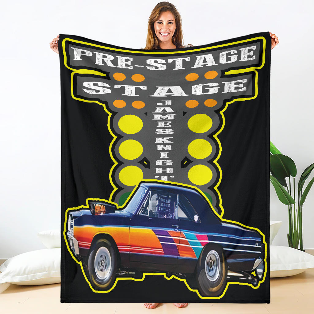 A woman holding a custom blanket with a drag racing theme, featuring a colorful image of a car on a black background with the text 'PRE-STAGE JAKEENKO'.