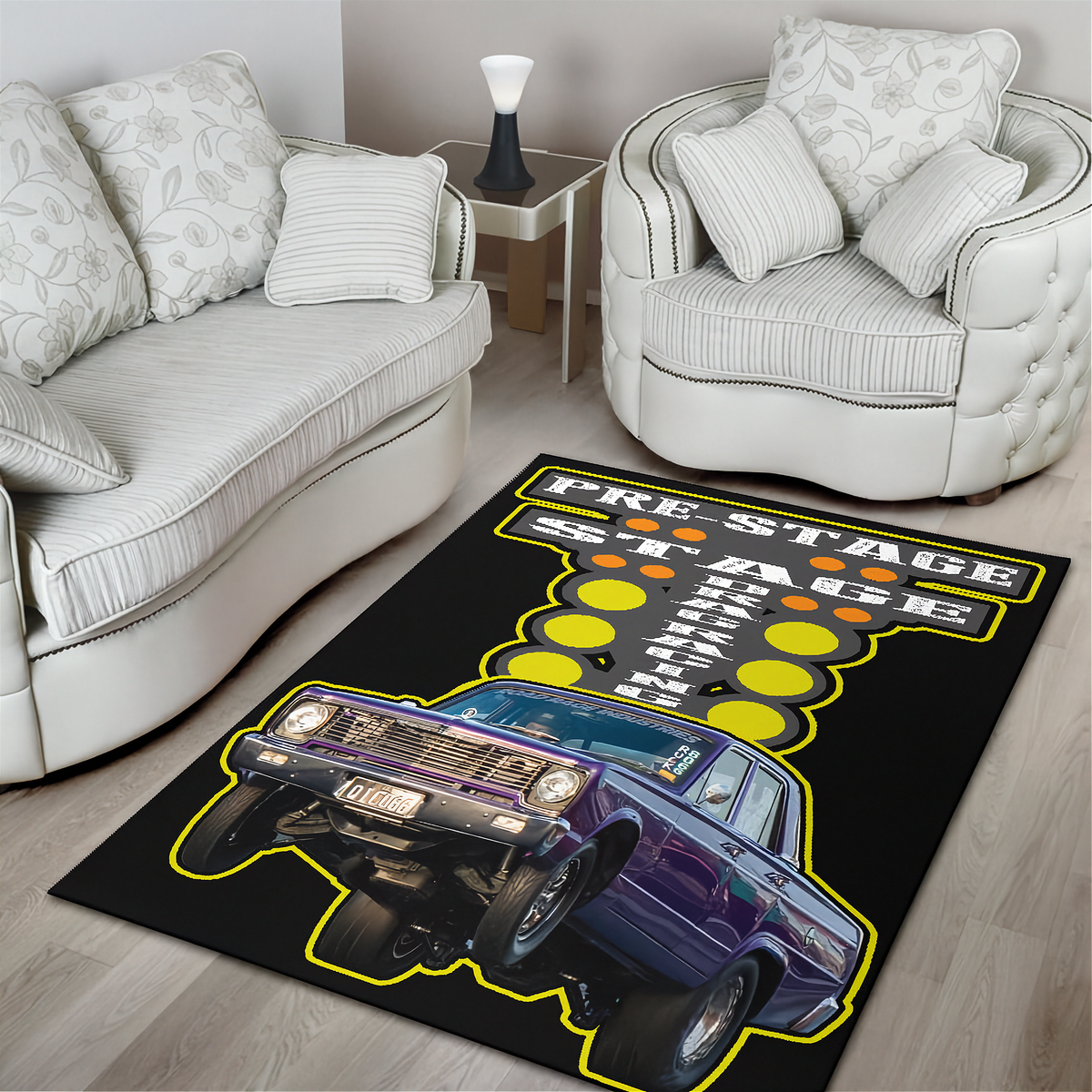 A rectangular area rug with a graphic design of a purple classic race car and the words 'PRESTAGE RACE NIGHT' on a black background, shown in a living room setting between two white armchairs.