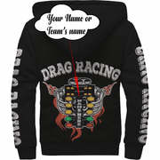 Black sherpa hoodie shown from the back with a large drag racing graphic featuring a chrome engine, flames, and the words 'DRAG RACING' across the upper back. The sleeves also have vertical white text reading 'DRAG RACING'.