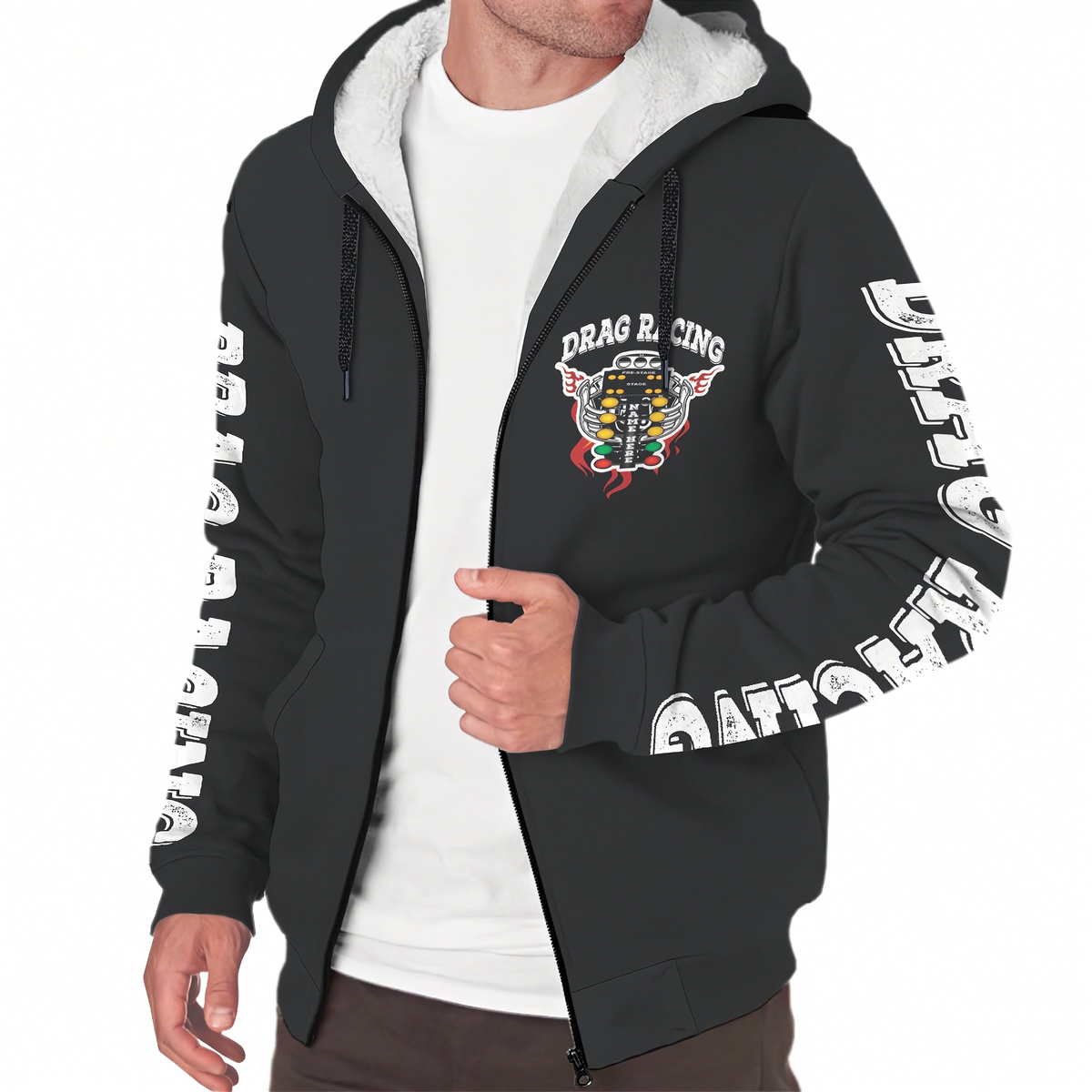 A man wearing a black zip-up hoodie with a white sherpa-lined hood, featuring a 'DRAG RACING' graphic on the left chest and white text graphics down both sleeves, layered over a white t-shirt.