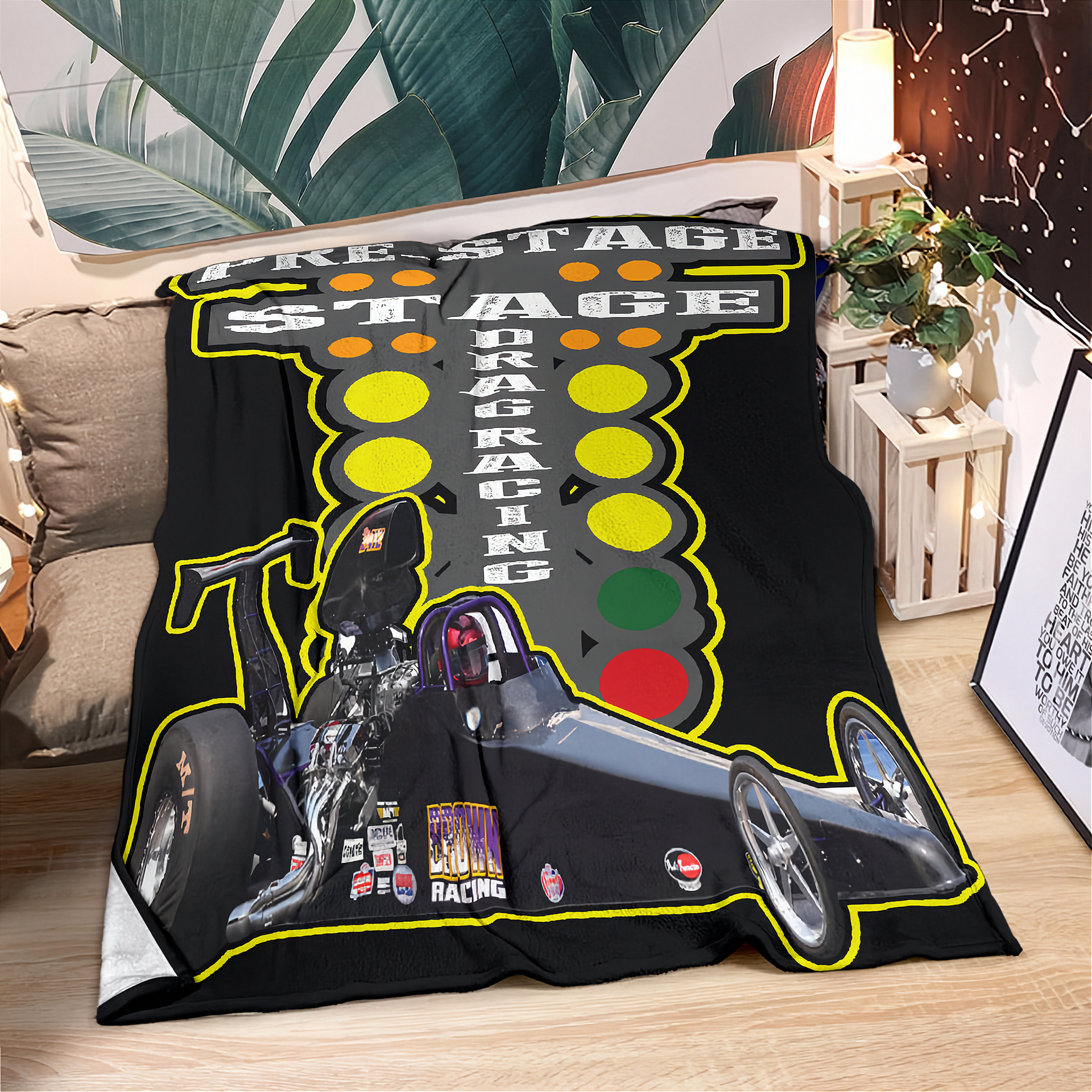 Blanket with racing design featuring a traffic light and motorcycle on a couch.
