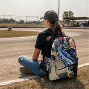 a girl sitting in a karting arena and wearing a custom kart racing backpack
