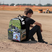 a little boy sitting in a karting arena and wearing a custom kart racing backpack