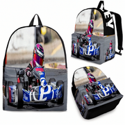 A backpack shown from multiple angles on a white background, featuring a full-color printed graphic of a go-kart racing scene with a driver in a blue, white, and red kart.