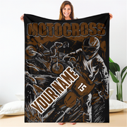 Woman holding a brown and black custom motocross blanket with dirt bike rider artwork, “Your Name” placeholder and sample number 15.