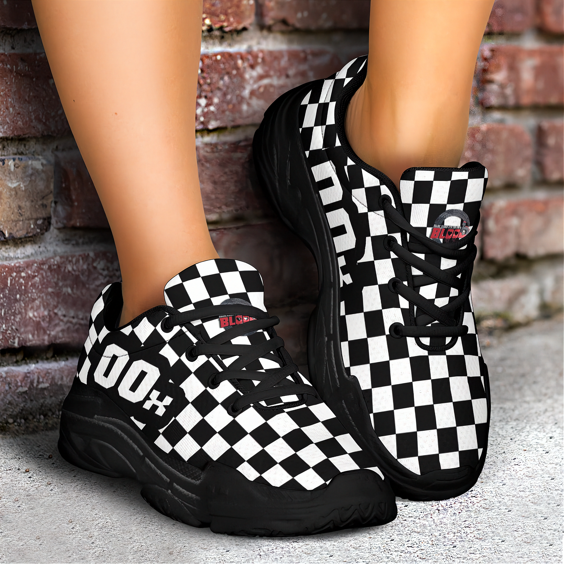 Black and white checkered sneakers worn by a person against a brick wall.