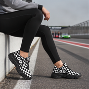 Woman wearing black and white checkered shoes on a race track