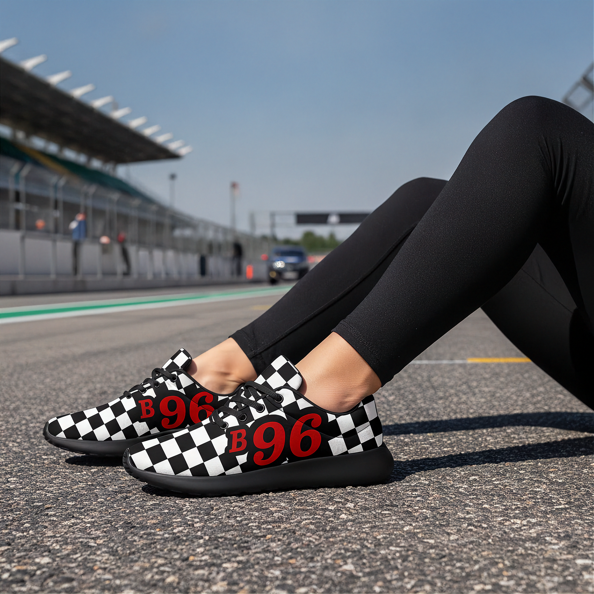 Checkered shoes with 'B 96' on a racing track