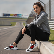 Woman sitting on a race track wearing checkered shoes with numbers