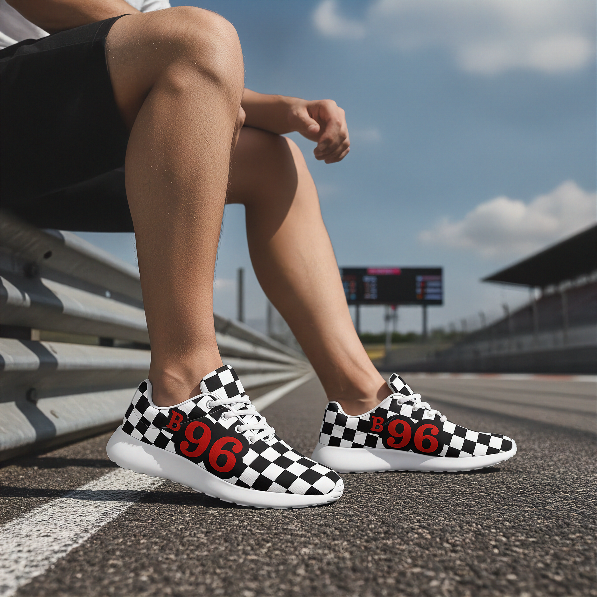 Person wearing checkered sneakers with 'B96' on a race track.
