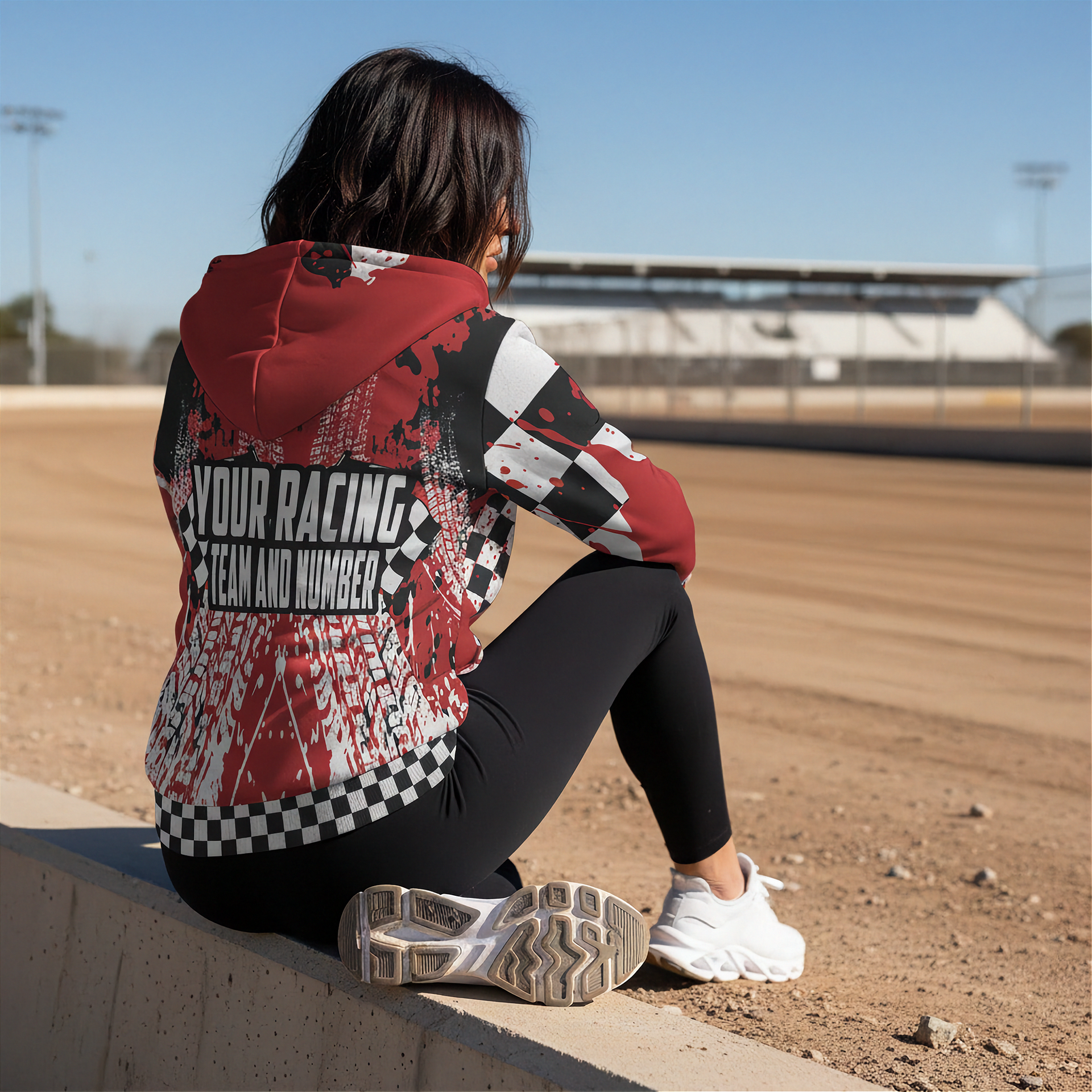 woman sitting at a dirt track arena wearing a custom racing sherpa jacket