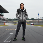 Woman in a patterned racing sherpa jacket standing on a race track