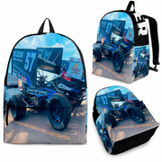 A backpack shown from multiple angles on a white background, featuring a full-color wraparound print of a blue and white race car with racing flags and sky. The backpack has black straps and black trim, and the print includes visible racing sponsor graphics.