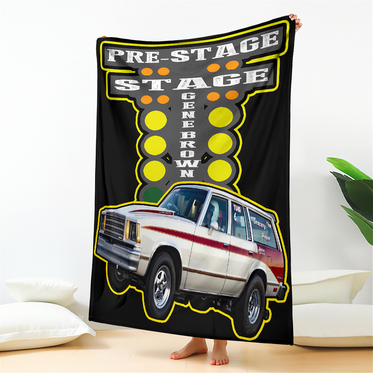 Blanket with a graphic of a car and text on a black background