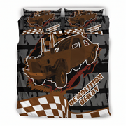 A bedding set featuring a custom dirt-track racing design, including a duvet cover and two matching pillowcases. The graphic features a brown race car, a black and white checkered flag motif, and the text 'DEMOLITION DERBY' over a dark gray grunge background.