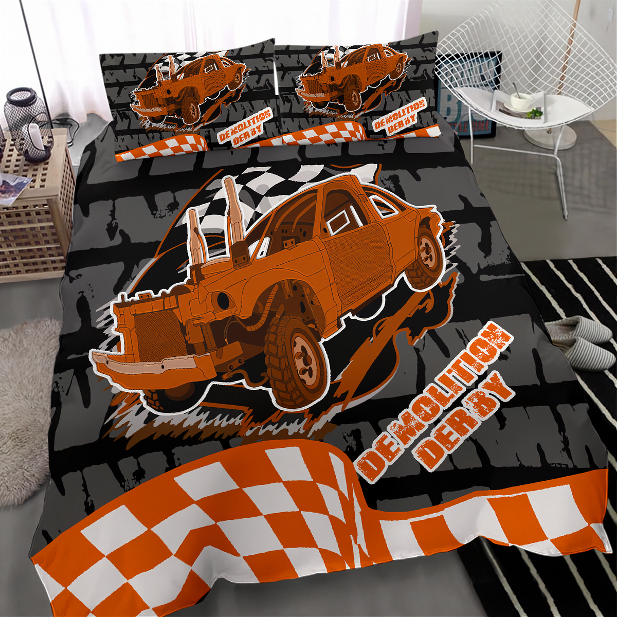 A bedding set featuring a cartoon-style orange demolition derby car on a black and gray brick-patterned background, with orange-and-white checkered stripes and the words 'Demolition Derby.' The set is shown on a bed in a bedroom setting with a chair, side table, and rug visible.