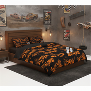 A racing-themed bedding set with a black and orange camouflage pattern, styled on a wooden bed frame in a rustic, industrial-themed bedroom with racing posters and truck decor.