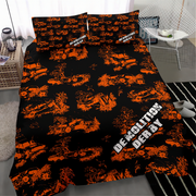A bedding set with a black duvet cover and matching pillowcases featuring a distressed orange military pattern of tanks and explosions, with the text 'DEMOLITION DERBY' in white. The set is displayed on a bed in a modern, styled bedroom setting.