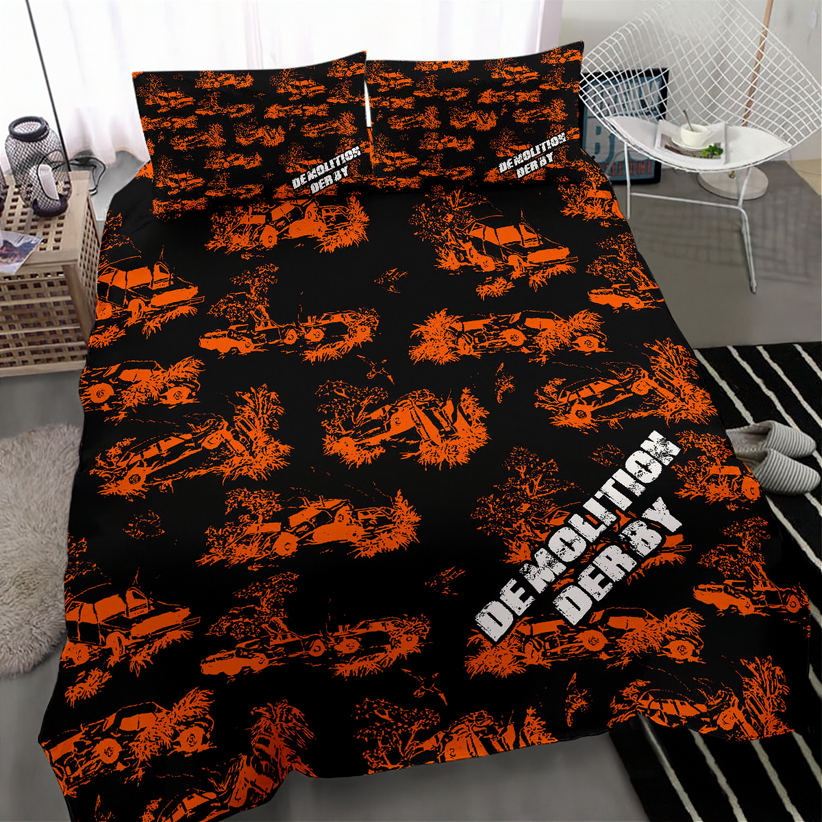 A bedding set with a black duvet cover and matching pillowcases featuring a distressed orange military pattern of tanks and explosions, with the text 'DEMOLITION DERBY' in white. The set is displayed on a bed in a modern, styled bedroom setting.