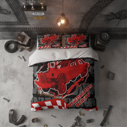 A top-down view of a bed styled in a garage-themed room, featuring a red DemolitionDerby truck graphic on a black and gray duvet cover and matching pillowcases.
