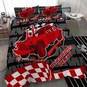 A racing-themed bedding set featuring a large red demolition derby truck graphic on a black and gray background, with red-and-white checkered accents and matching pillowcases, shown styled in a bedroom setting.