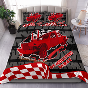 A racing-themed bedding set displayed on a bed in a bedroom setting. The set includes a duvet cover and two matching pillowcases featuring a red race car, a black and white checkered flag pattern, and the words 'DEMOLITION DERBY'.