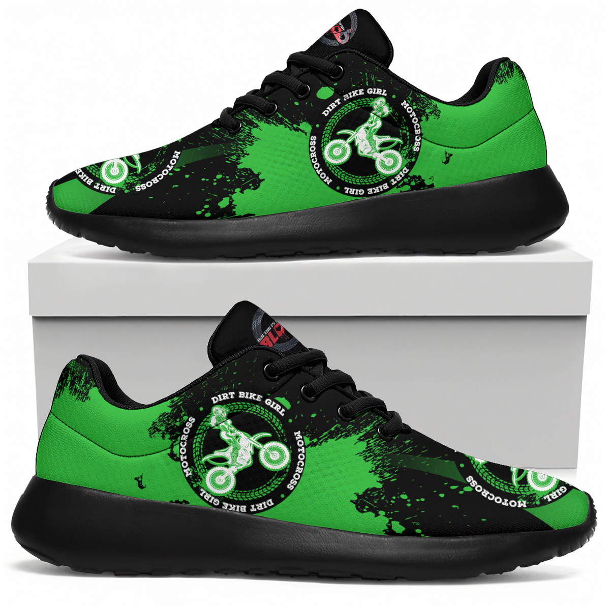 A pair of low-top sneakers shown from the side, with one shoe resting on top of a white box and the other below. The shoes have a bright green and black paint-splatter design with a circular graphic featuring a dirt bike rider and the text 'DIRT BIKER GIRL' and 'MOTOROGAS'.